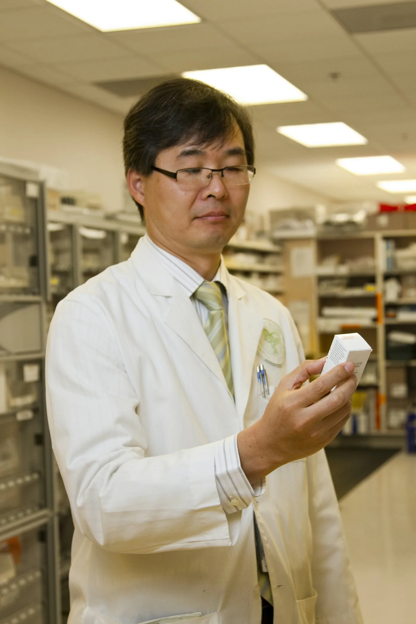 A pharmacist preparing medication at a professional workstation